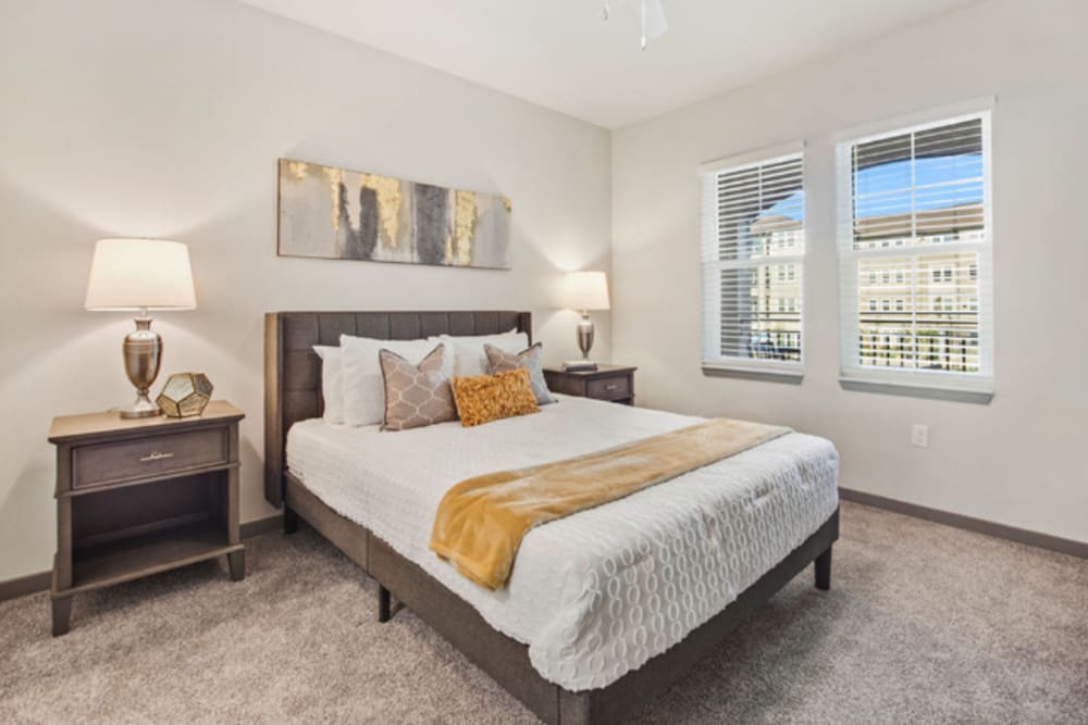 Spacious master bedroom with ceiling fan at Murano at Three Oaks in Fort Myers, Florida