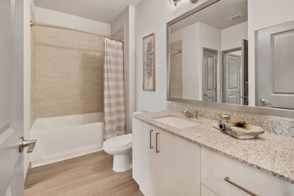 Bright and clean bathroom with ample cabinetry at Murano at Three Oaks in Fort Myers, Florida