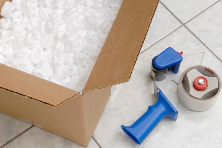 Box filled with packing peanuts next to packing tape at Bay Area Self Storage in San Carlos, California