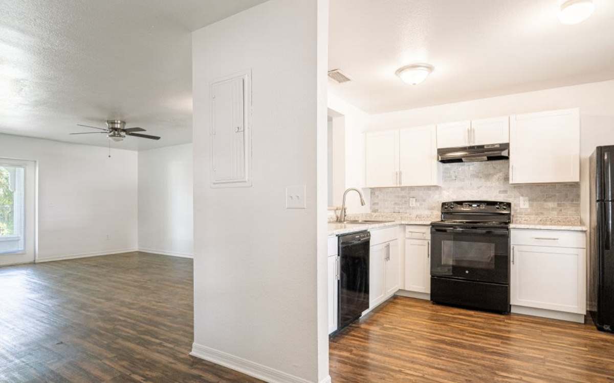 Modern kitchen with wooden cabinets at Cypress Commons in Wildwood, Florida