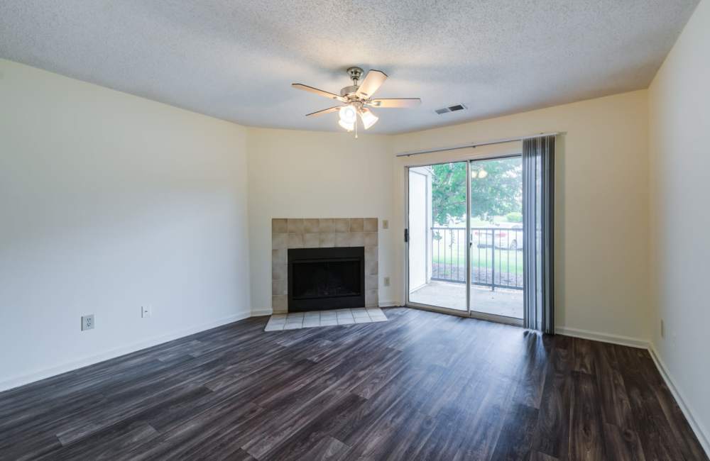 Living room with sliding glass door at Chason Ridge Apartment Homes in Fayetteville, North Carolina