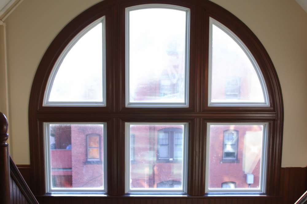 Natural light flooding through large arched windows at Bh Tapley Court in Springfield, Massachusetts