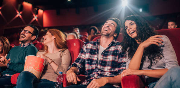 Residents watching movie in the theatre near The Courtney at Lake Shadow in Orlando, Florida