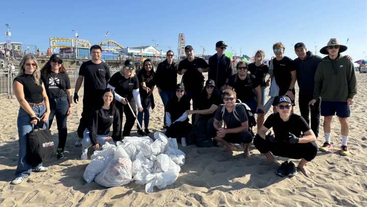 volunteers clean up trash on beach