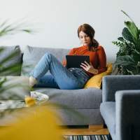 Resident relaxing in her apartment at Park at Kingsview Village in Germantown, Maryland 
