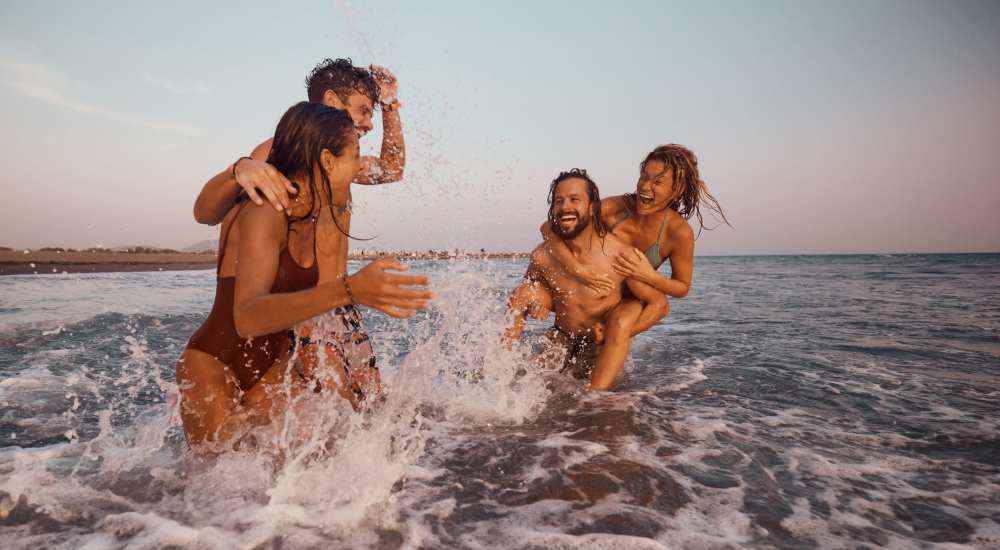 Residents with friend having drink near seashore near The Boulevard Apartment Homes in Woodland Hills, California