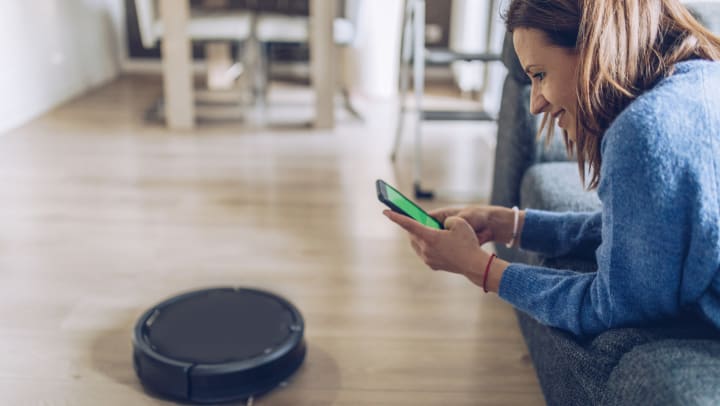 Woman controlling a vacuum with her phone at Olympus Corsair in San Diego, California
