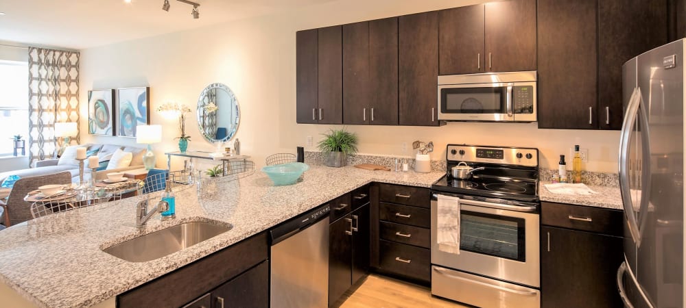 Spacious kitchen with brown cabinet at The Residences at Annapolis Junction in Annapolis Junction, Maryland