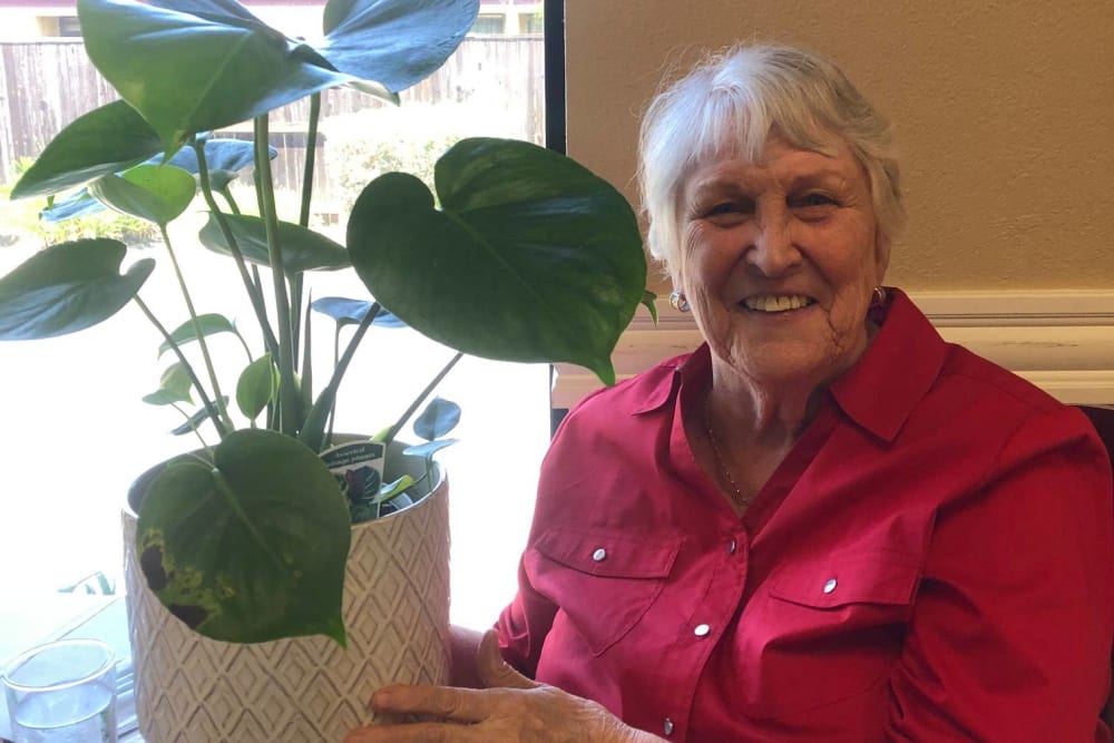 Resident holding a plant at Lodi Commons Senior Living in Lodi, California