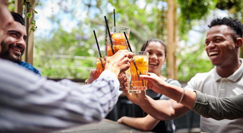 Group of residents having drinks together at a restaurant near Laurel Woods Apartments in Smyrna, Tennessee