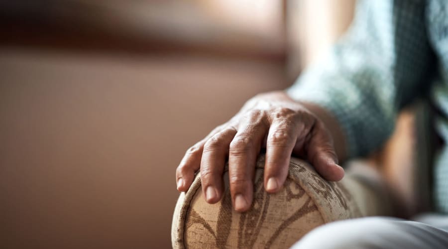 Resident relaxing in a comfortable chair at Cascade Park Vista Assisted Living in Tacoma, Washington