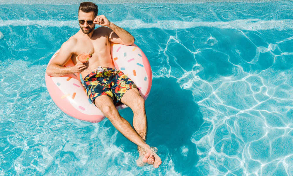 Man having a good time in the swimming pool at Stone Village Apartments in Reno, Nevada