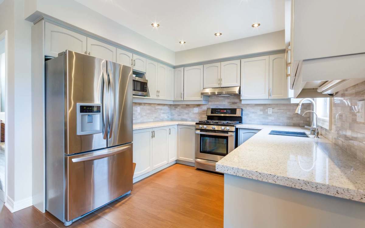 Kitchen with stainless-steel appliances at Cypress Oaks in Leesburg, Florida