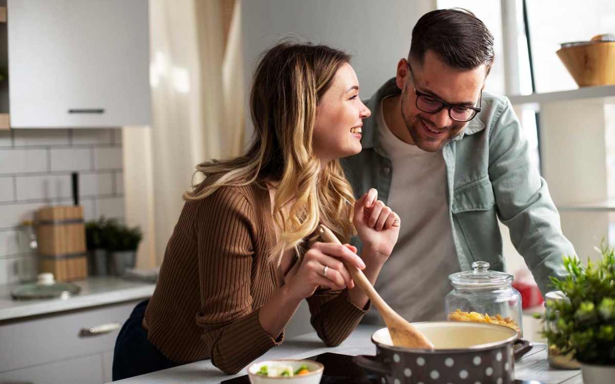 Resident couple cooking in their kitchen at Bostonia in El Cajon, California