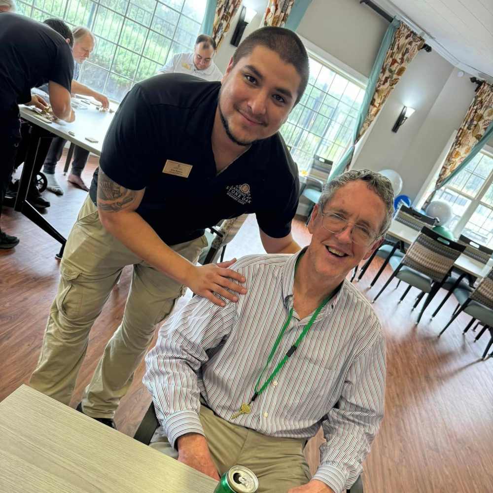 Resident with staff at The Landing at Stone Oak Memory Care in San Antonio, Texas