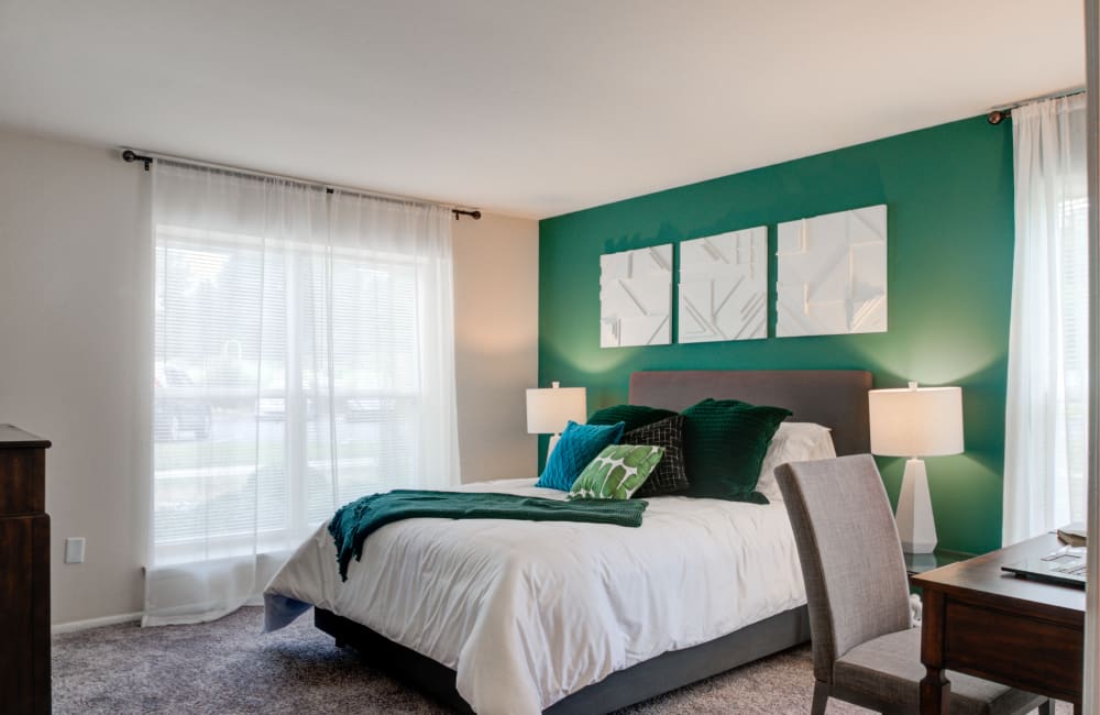 Carpeted model bedroom with an accent wall at The Preserve at Milltown in Downingtown, Pennsylvania