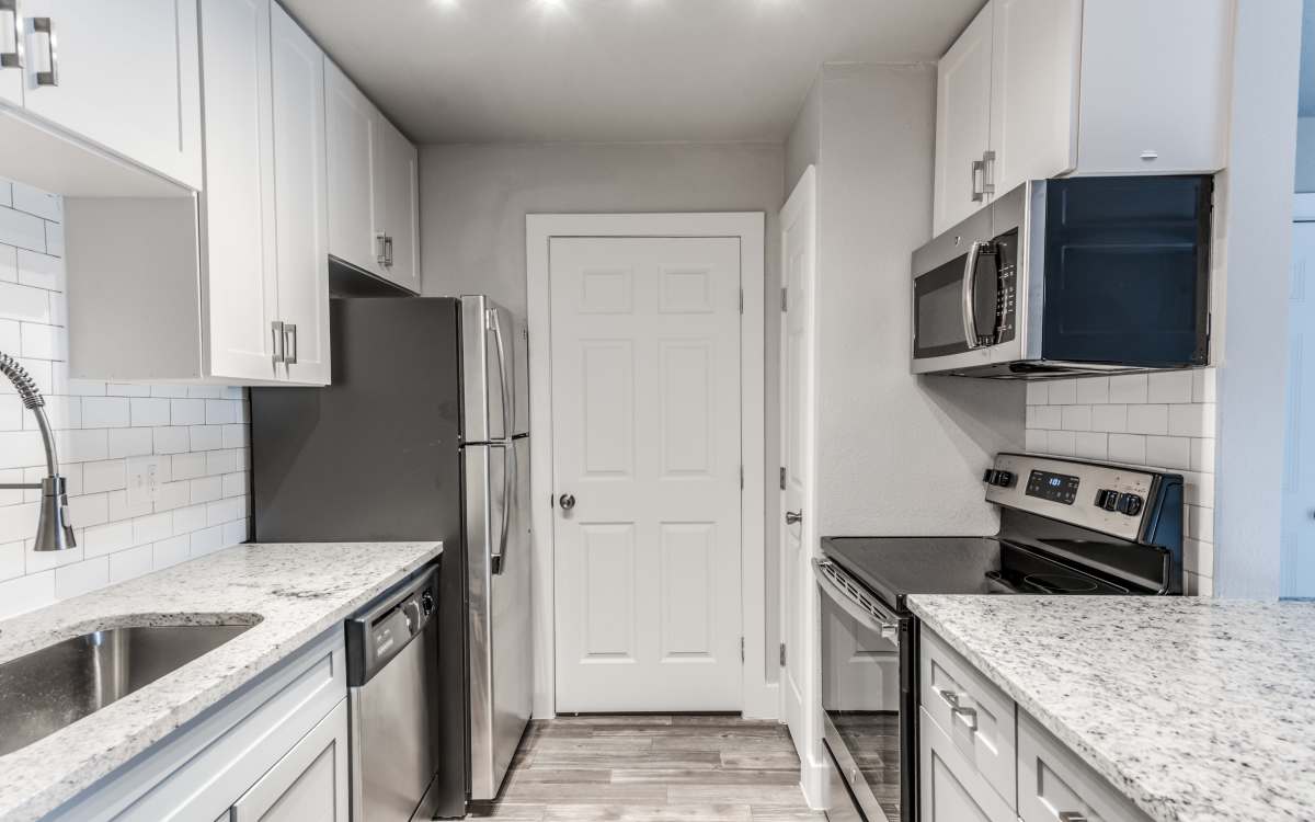 Kitchen with refrigerator at The Brighton in Houston, Texas 