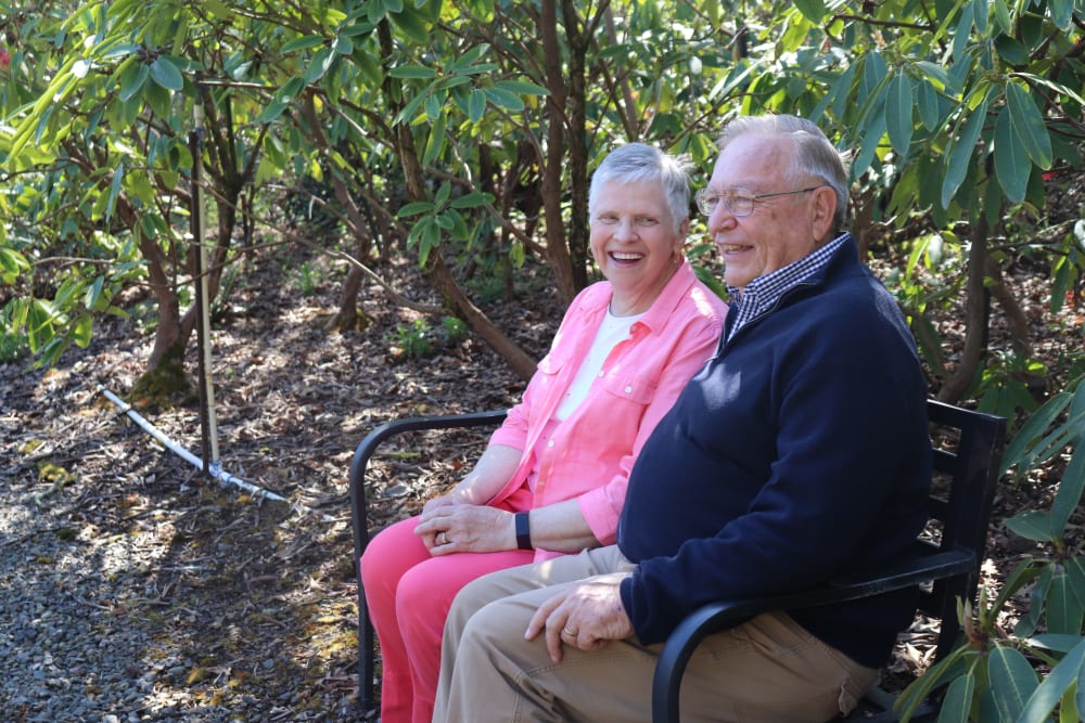 Two residents sitting in the gardens at The Springs at Greer Gardens in Eugene, Oregon.