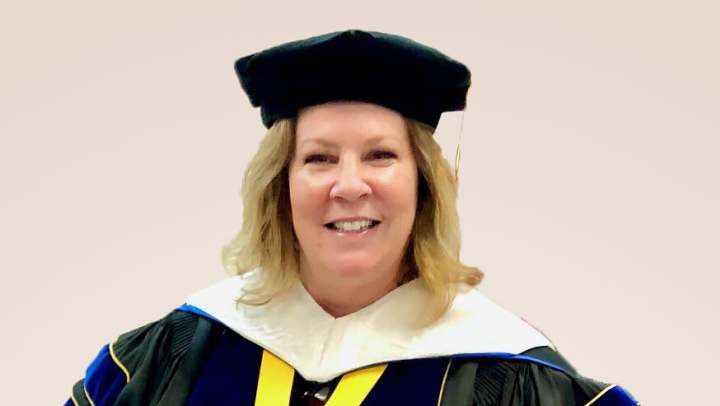 Kellie J. Falk in a graduation cap and gown