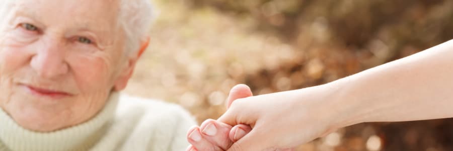 Resident holding hands with a younger family member at Retirement Ranch in Clovis, New Mexico