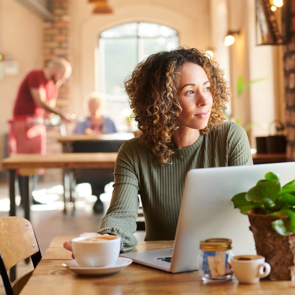 Resident working at a coffee shop near Kenneth Park Apartments in Carmichael, California