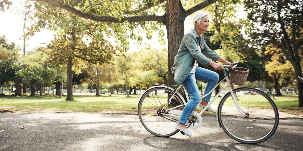 Residents riding her bike through a park in Seattle, Washington near Columbia Gardens