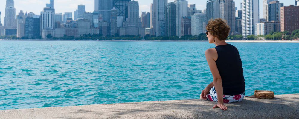 Woman resting on the water enjoying a lovely view of the city near The Main in Evanston, Illinois