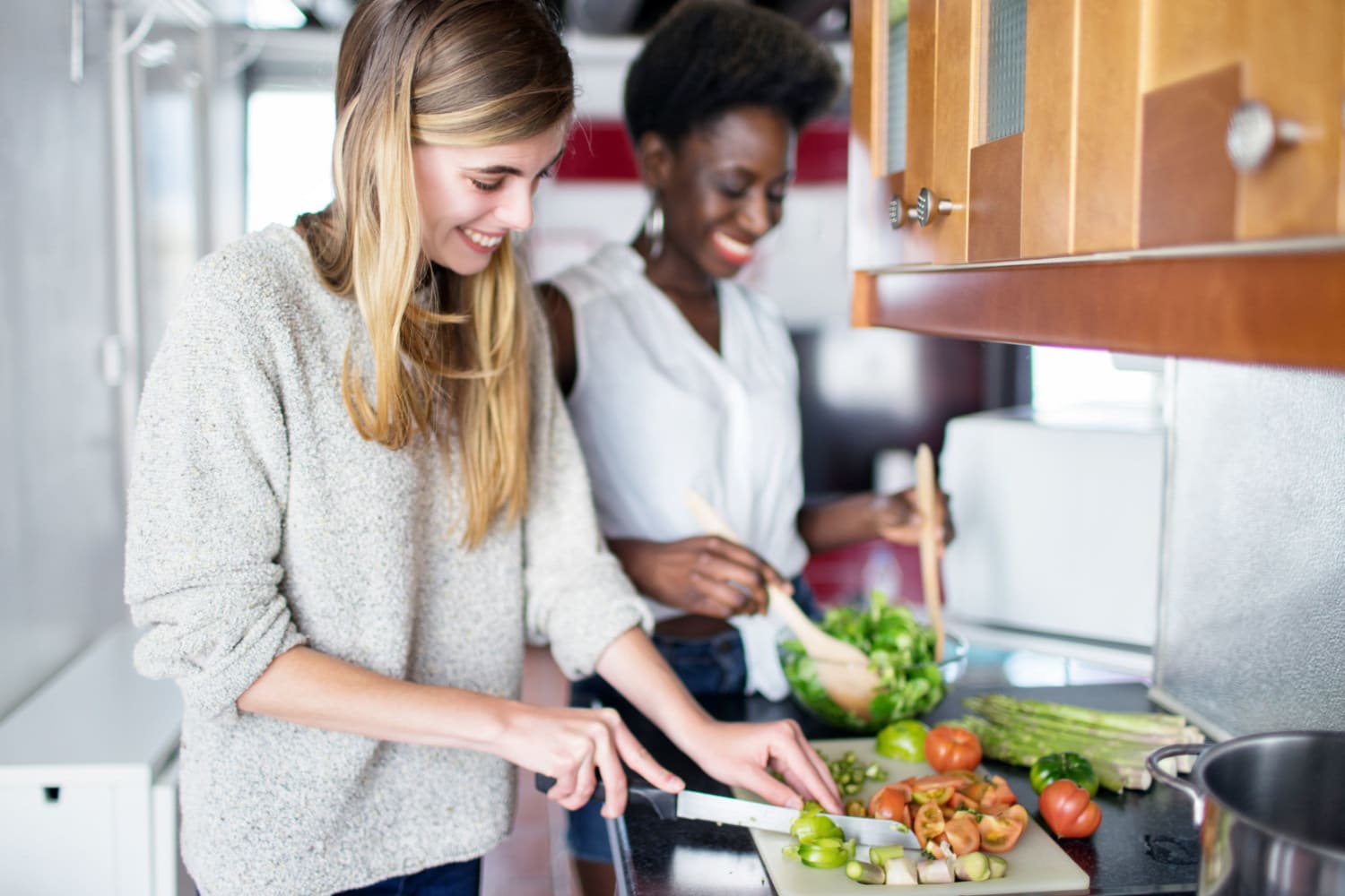 Resident friends preparing a meal in their home at Lutkin Bayou Apartments in Drew, Mississippi
