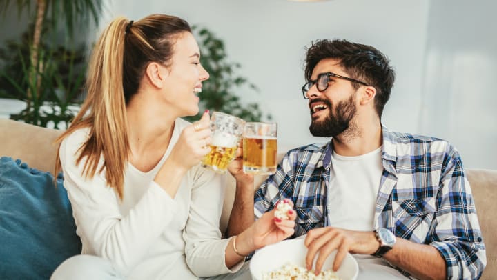 Resident couple enjoying cold beers in the comfort of their new home at The Slate in Savannah, Georgia
