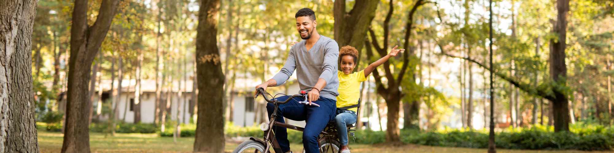 A father and daughter riding a bike at Map + Directions | Parkside at Mirabeau in Spokane Valley, Washington