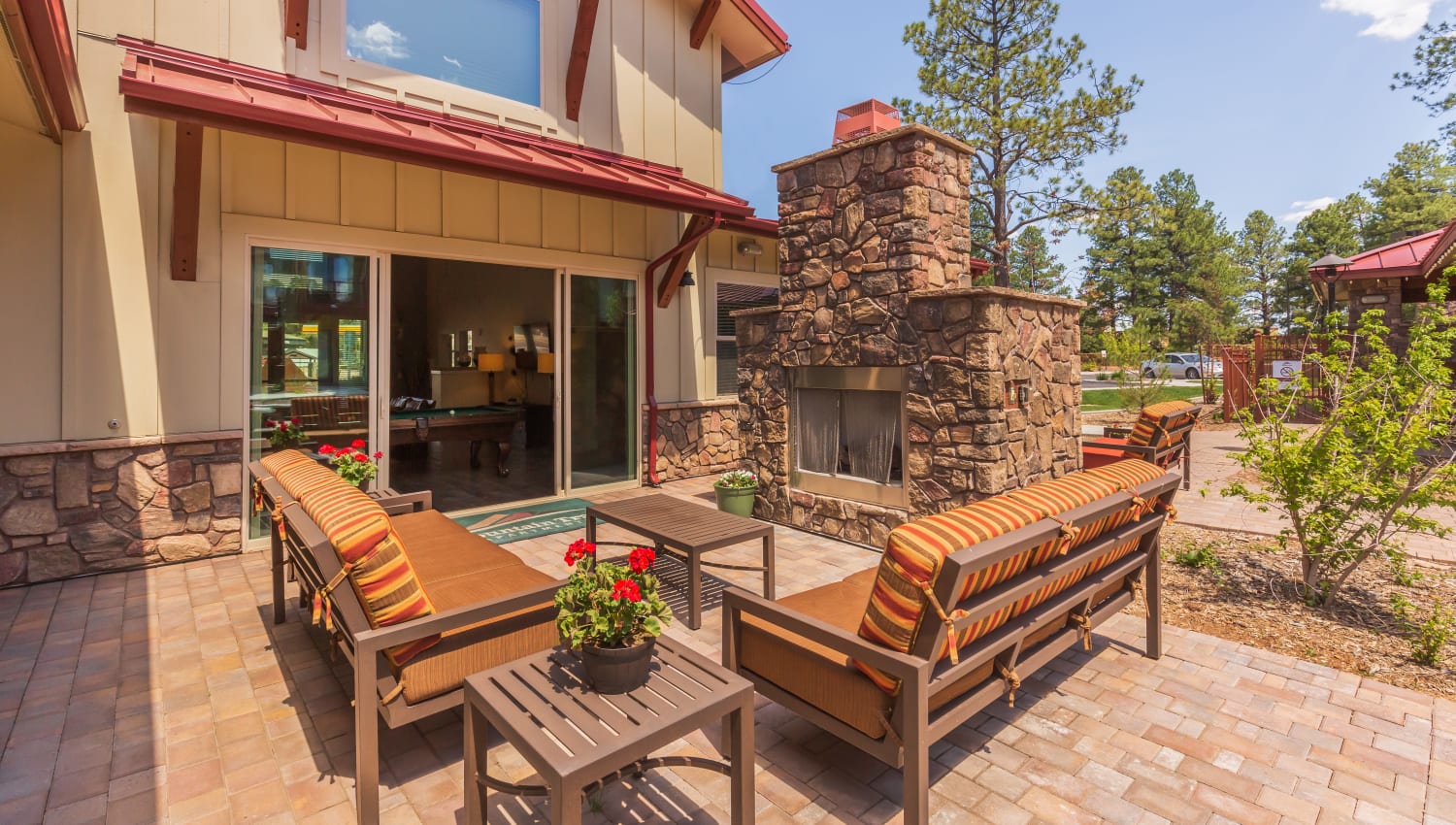 Outdoor patio seating by a beautiful stone fireplace at Mountain Trail in Flagstaff, Arizona