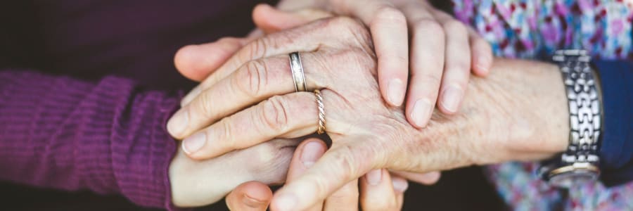 Caretaker hand-in-hand with a younger family member at East Troy Manor in East Troy, Wisconsin