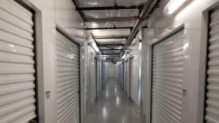 A bright hallway with white storage unit doors at Extra Attic Mini Storage in Richmond, Virginia