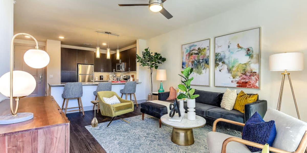 Well-decorated open-concept living space in a model home at The Nash in Dallas, Texas