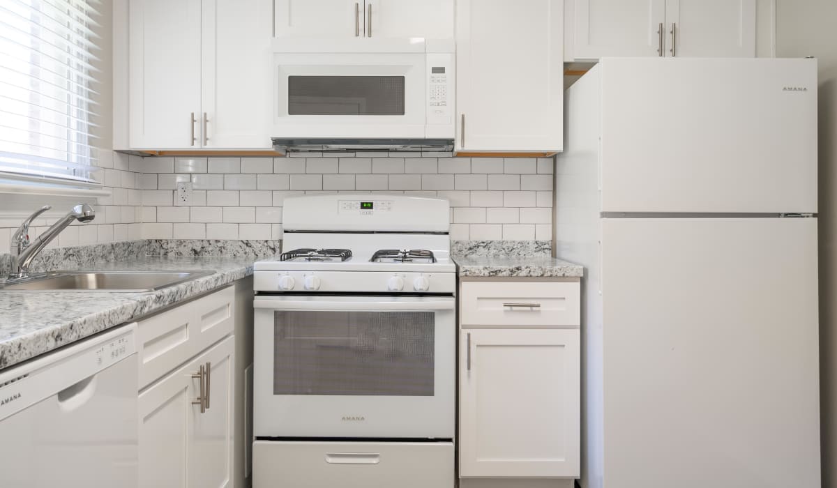 Apartment kitchen with white appliances at Deering Manor in Richmond,Virginia