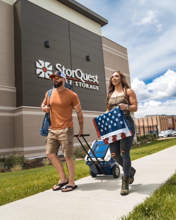 couple carrying a flag at StorQuest Self Storage