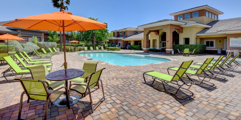 Sparkling pool and poolside seating at Canyon Villas Apartments in Las Vegas, Nevada