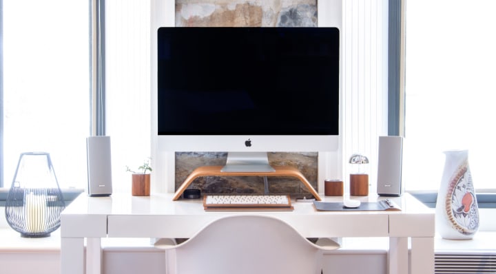 a small desk with ergonomical function with keyboard and monitor lifted