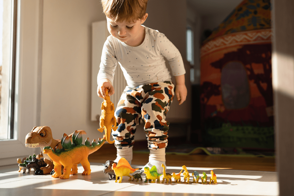 Resident kid playing with dinosaurs at The Millton in Redwood City, California