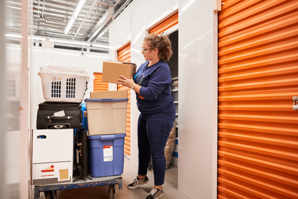 A customer moving items into her storage unit at BuxBear Storage in San Francisco, California