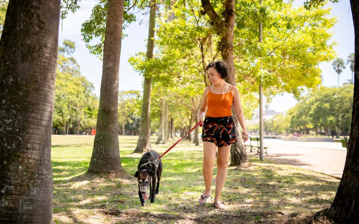 Resident walking their dog through a park near Huffman Mill Townhomes in Burlington, North Carolina