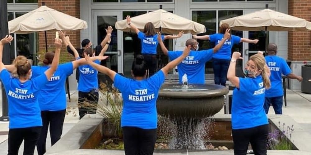 A group of staff members pose for a picture at Merrill Gardens.