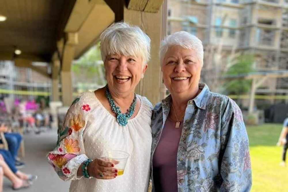 Residents enjoying tea and sunshine outside at Watercrest at Katy in Katy, Texas