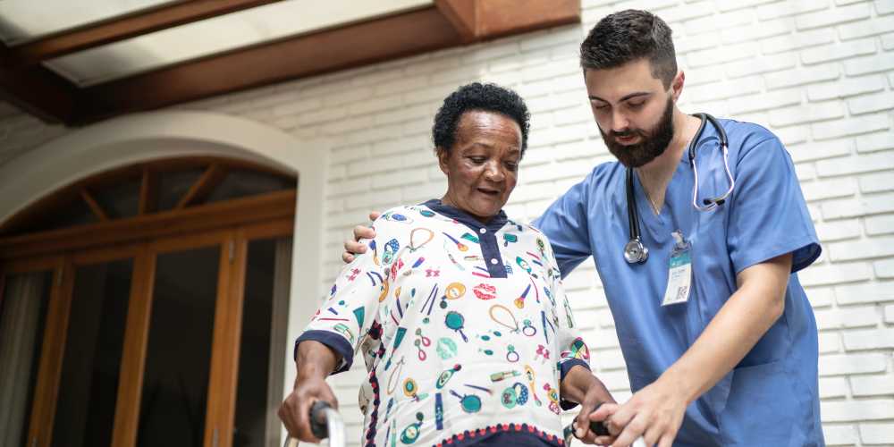 A staff member helping a patient walk at Careage at Home in Bellevue, Washington. 