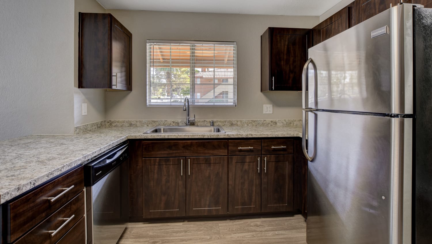 Kitchen with stainless-steel appliances at Invitational Apartments in Henderson, Nevada