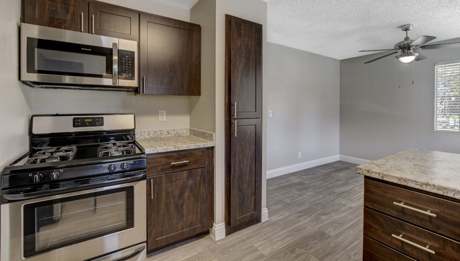 Model kitchen with vinyl wood flooring at Artisan Apartments in Las Vegas, Nevada
