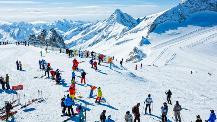 Skiers on mountaintop at winter ski resort Hintertux, Tirol, Austria.