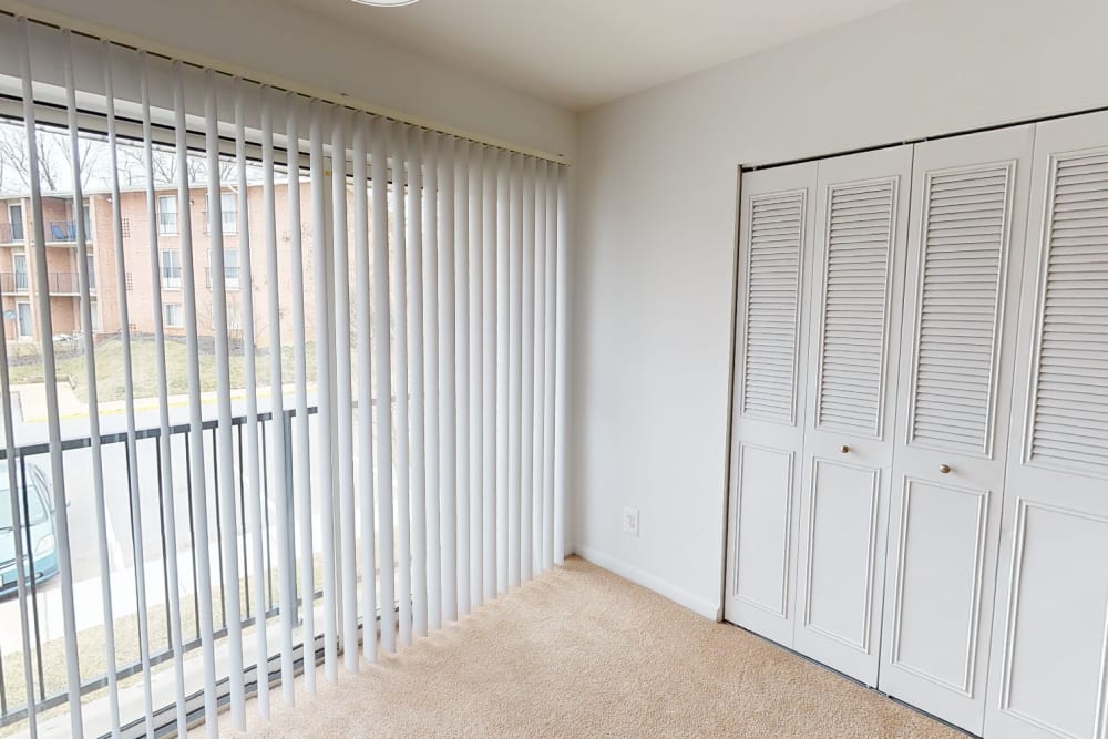 Large windows for natural light in the bedroom at Hampton Manor Apartments and Townhomes in Cockeysville, Maryland