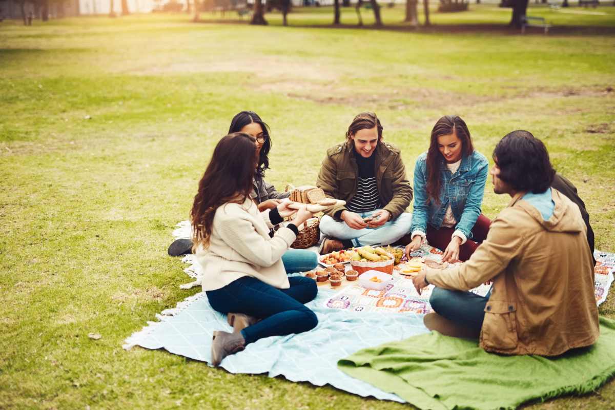 Students hanging out together in a park near Eclipse on Broad in Athens, Georgia