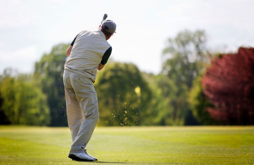 Resident playing golf at a golf course in Roseville, California near Roseville Commons Senior Living